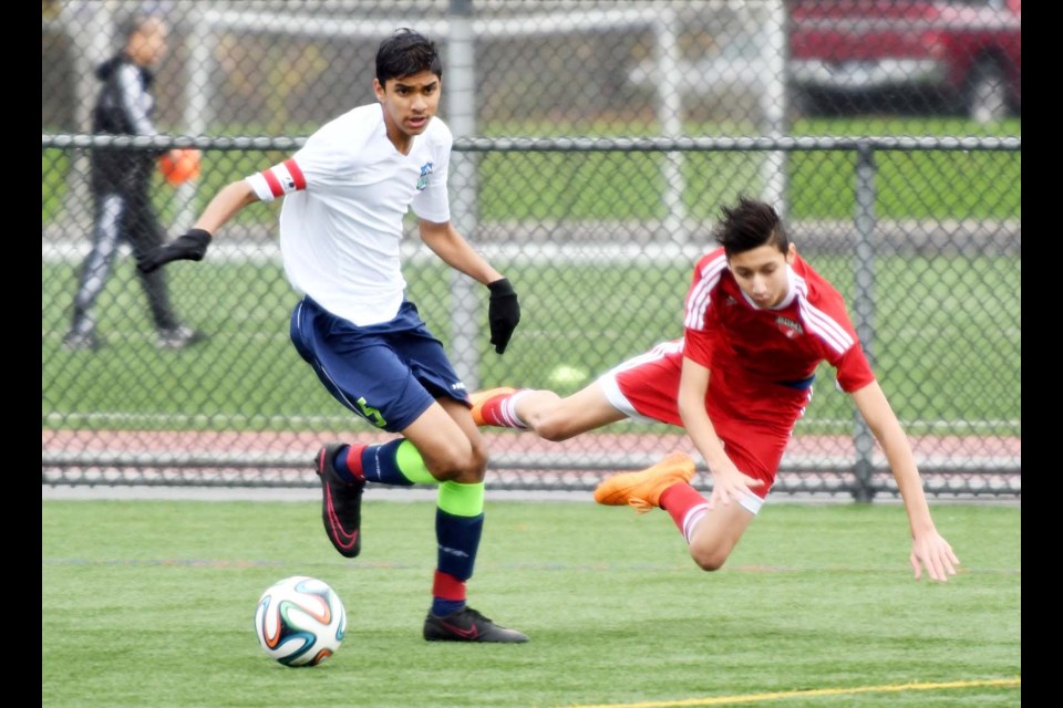 Fraser Valley’s Mohit Bhatoa, left, wins the battle for the ball this time with Burnaby District FC’s Benoit Lutz during their under-14 metro soccer game. Lutz would set-up the game-winning goal, as Burnaby won 1-0.