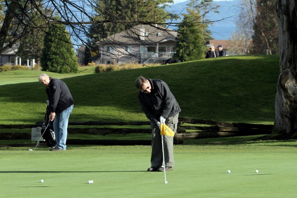 Players putt on a green at the picturesque Cordova Bay Golf Course, adjacent to Mattick&Otilde;s Farm and close to a proposed development on former Trio Ready-Mix Ltd. gravel pit lands.