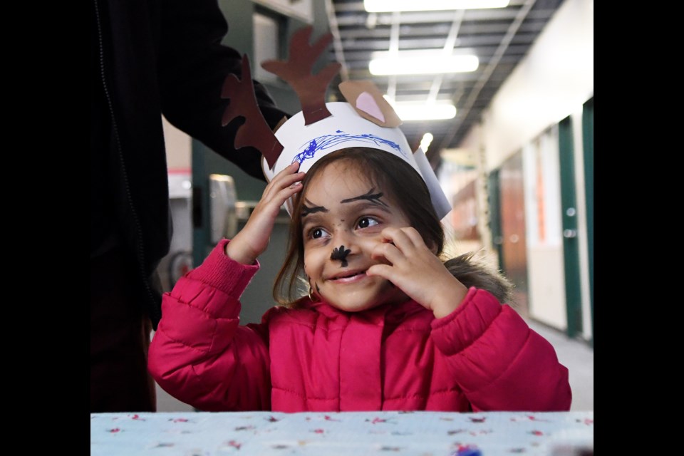 Three-year-old Zaara Punjani sports her reindeer hat.