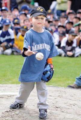 Oliver Gray throws an opening pitch at the Forest Hills Little League opening day.