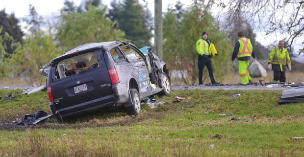 Crews investigate and clean up after a collision between a van and a semi-truck on Ladner Trunk Road Wednesday.