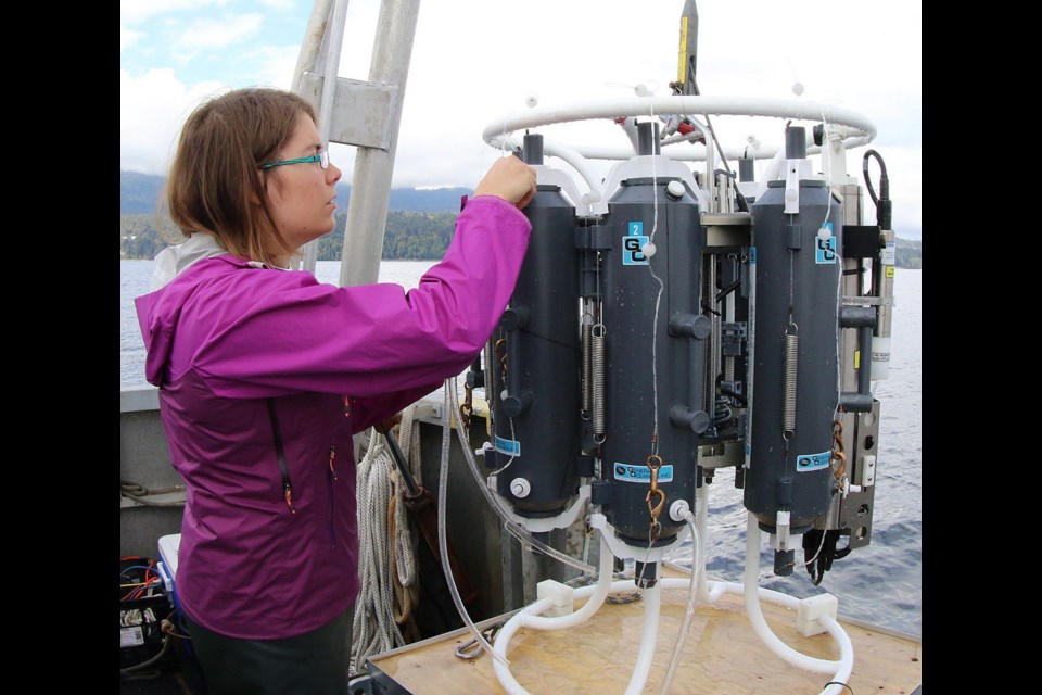 University of Victoria student Erinn Raftery adjusts the equipment used to collect water samples in Saanich Inlet.