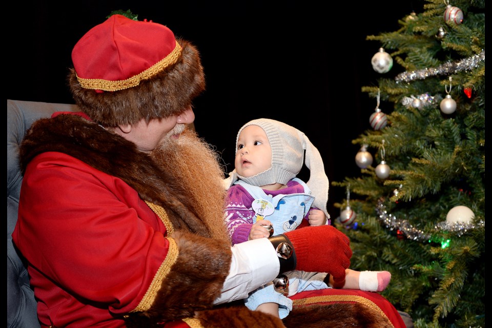 Father Christmas and seven-month-old Mabel Smith of Surrey. Father Christmas is available for visits at Stride Studios for Burnaby Village Museum's Heritage Christmas.