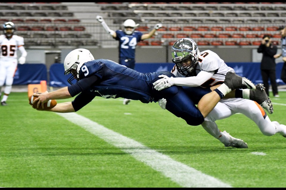 New Westminster's Liam Mackay can't prevent Notre Dame's Steven Moretto from scoring his team's second touchdown during Saturday's B.C. High School football semifinal at BC Place.