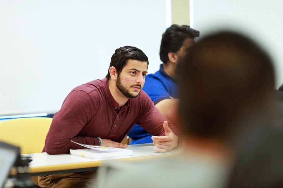 SFU student and Voices Against Extremism member Hussein Assad takes part in discussions in professor Richard Frank's advanced issues in cybercrime class at SFU's Burnaby campus.