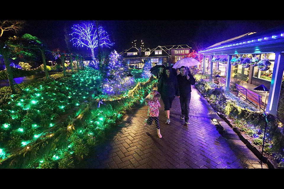 The Kelly family — Alexys, 4, Laura and Mike — enjoy the lights during the annual Christmas Light-Up at Butchart Gardens.