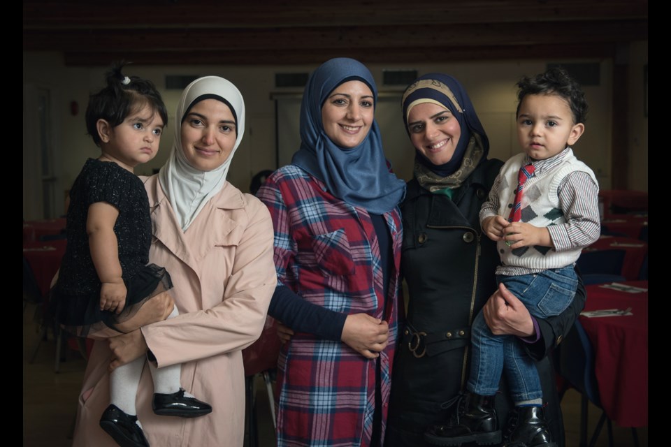 From left to right, Manar Alsaid Ahmed with daughter Salma, Leena Al Ahmad and Asmaa Qawas with son Motaz, were just some of the Syrian refugees who hosted Saturday’s community dinner at the Mount Pleasant Neighbourhood House as a way of showing their appreciation to Canadians. Photo Rebecca Blissett