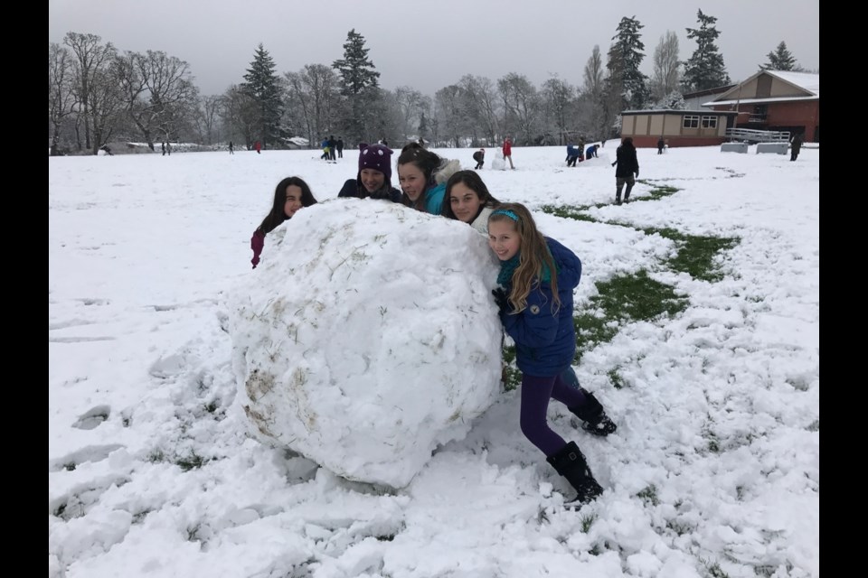 Rockheights Middle School students can’t get enough of the snow today. From left: Bianca Fiuza, Emily Renaud, Tatum Dicicco, Isabella Organ, and Sydney Jackson roll a giant snowball.