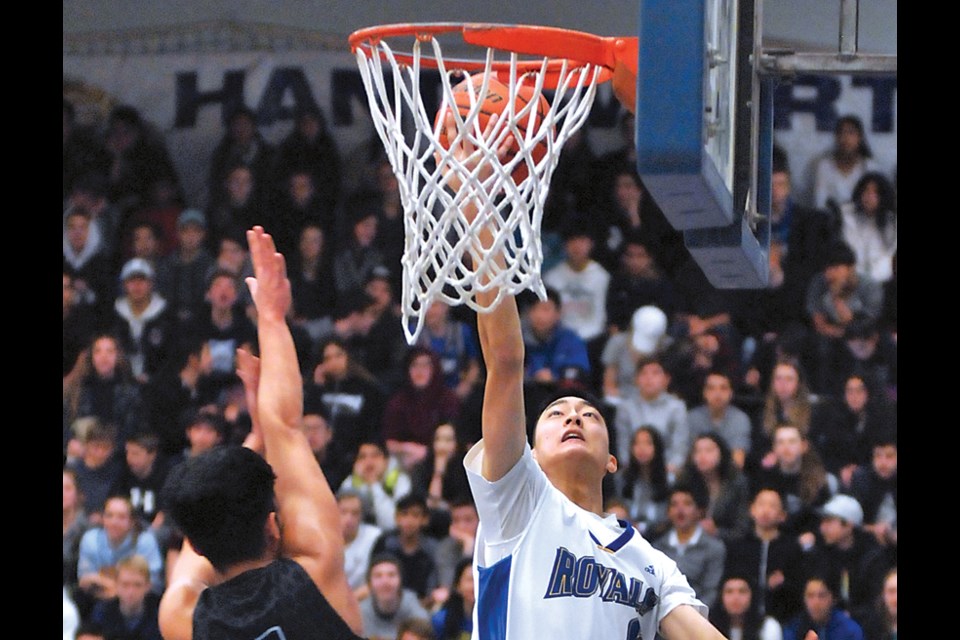 Handsworth’s Stanley Choo drives to the hoop during a Spirit Game played in front of a packed house on opening day of the No Regrets tournament. photo by Paul McGrath, North Shore News