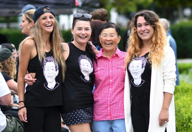 Monica Adey, Lynn McQuigge and Amy Byers pose with Joyce Wong while wearing T-shirts that bear her face. Photo Jennifer Gauthier