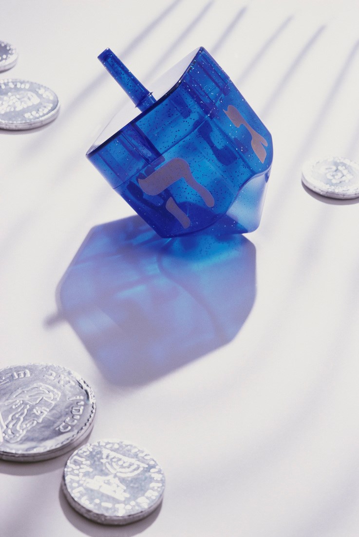Coins and Hebrew script on a dreidel