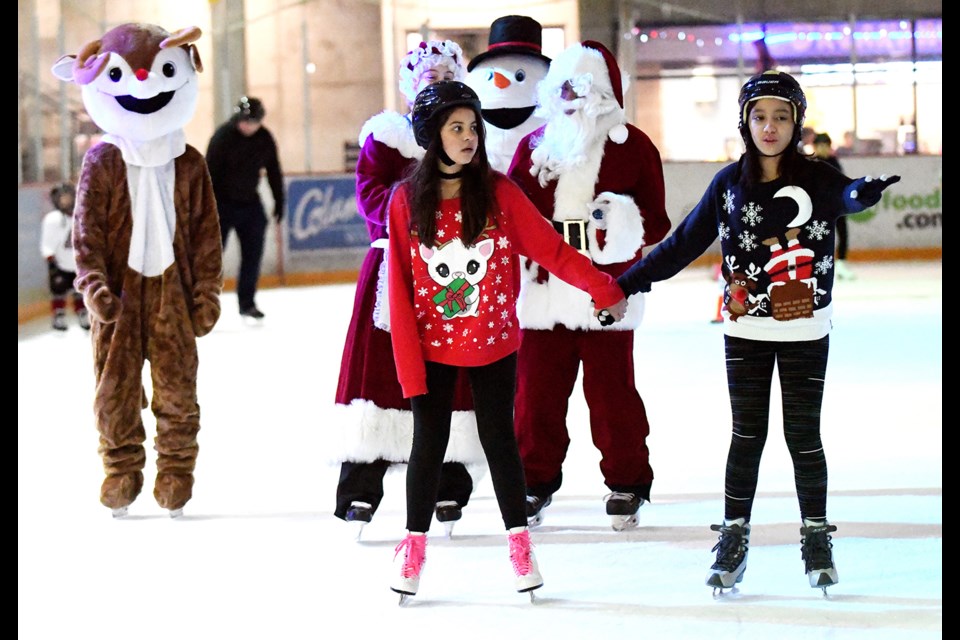 Anjali Trenholne, 11, and Melia Howse, 10, are dressed in their best for the Ugly Sweater Christmas Skate.
