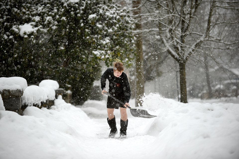 "It's not that cold," said Evan Pattison, sporting shorts to shovel the walk.