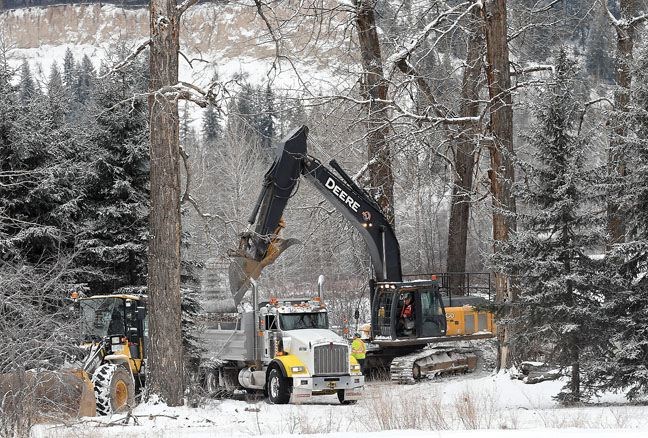 Crews do some work along  the Nechako River Tuesday morning including placing some rip rap on the river's bank.