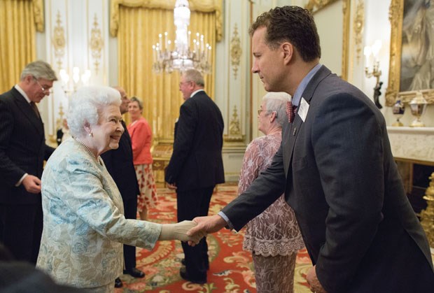 Craig Amundsen of Ladner shakes hands with Queen Elizabeth during a reception at Buckingham Palace last month.