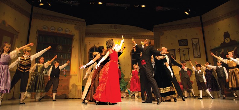 The Christmas party at the Stahlbaum household is the opening scene of The Nutcracker. The Stahlbaum hosts performed by Julian Alphilbert and Chelsea Minatsis are front and centre.