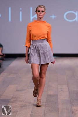 Elik & Afsi collection. A splash of orange with a classic high waisted skirt with pleating for extra detail.
