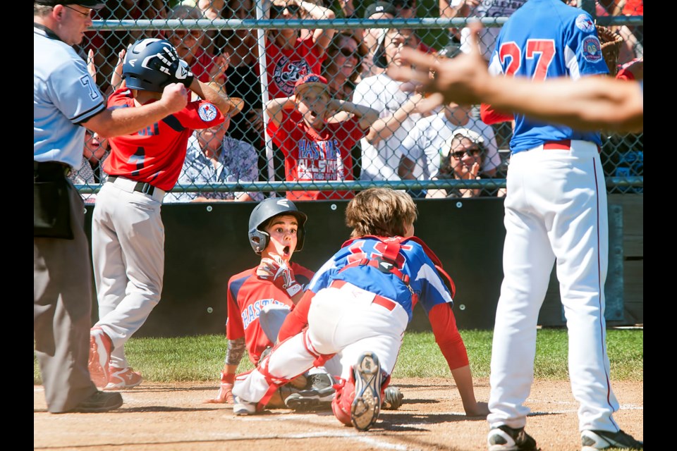 Hastings All-Stars’ Antonio Cusati looks shocked at being called out at the plate, seconds after teammate Matteo Ripoli scored what would be the game’s only run at the Canadian Little League final at Hastings Community Park in Vancouver.