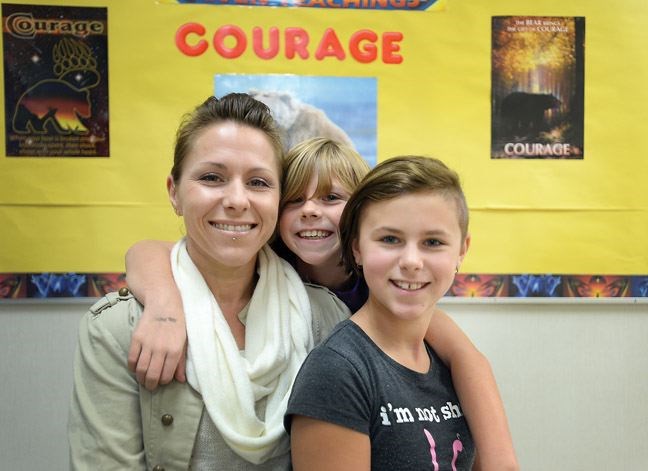 Sarah Dixon and her daughters Saleia Griffiths, 9, and Rebecca Griffiths, 12, smile while posing for a photo during a Strengthening Families Program session at Van Bien elementary on Oct. 28.