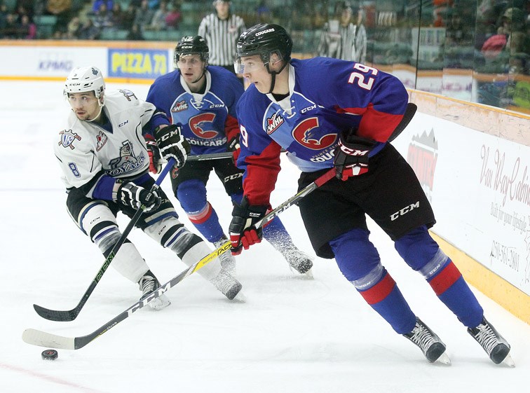 Cougars winger Nikita Popugaev sets up a play in front of Victoria Royals forward Ethan Price and Cougars centre Jansen Harkins during Saturday's game at CN Centre. The Cougars won 4-2.
