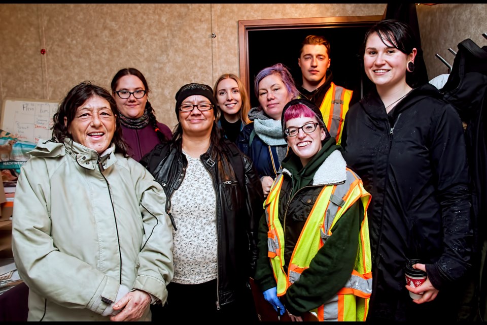Sarah Blyth (blue scarf) with her eclectic group of volunteers at the supervised injection trailer located within the Downtown Eastside Street Market on East Hastings. Chung Chow photo