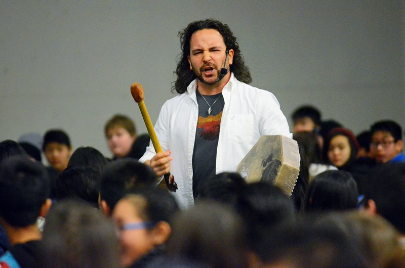 Indigenous storyteller Dallas Yellowfly of 3 Crows Productions drums while telling Burnaby North students the tale of "Qwalena: The Wild Woman Who Steals Children" during the school’s third annual Day of Truth and Reconciliation Monday.