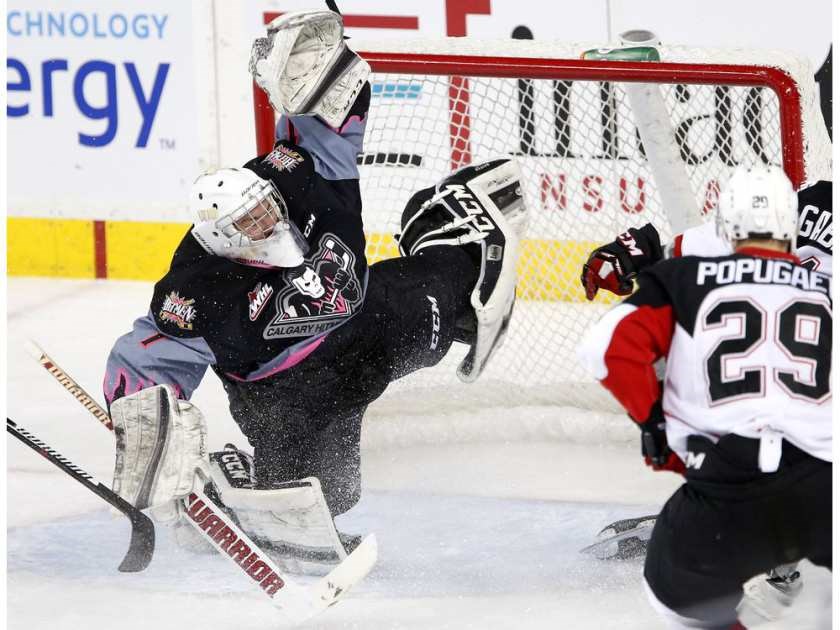 Calgary Hitmen goalie Trevor Martin loses his balance after Prince George Cougars right winger Jesse Gabrielle finished off a rink-length rush with a scoring chance during Saturday's game at the Scotiabank Saddledome in Calgary. The Cougars beat the Hitmen 5-4.