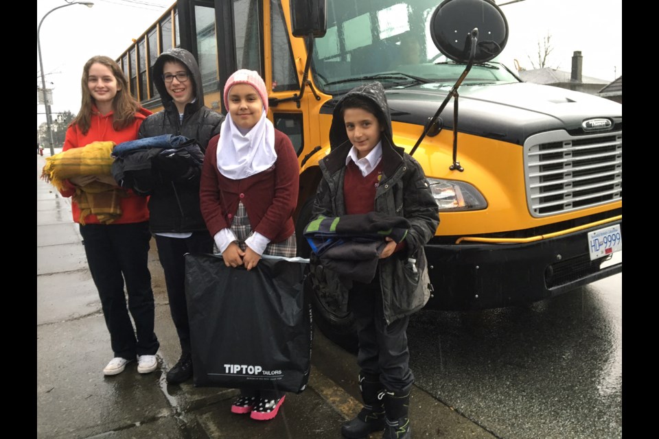 Students Emily Behr O’Leary, Noah Berger, Yasmin Abdullah and Yusut Savory took a bus to Vancouver Tuesday to hand out sandwiches and clothes. Photo by Graeme Wood/Richmond News