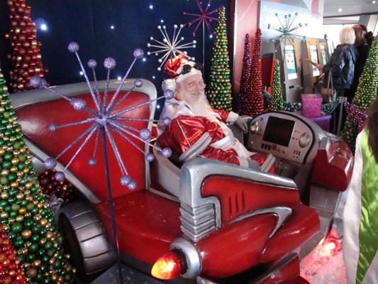 Santa takes a break from meeting children and posing for photographs in a lounge atop the Space Needle.