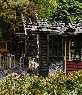 A VPD officer guards what's left of the train station at Stanley Park's Miniature Railway. Early Friday morning, fire gutted the structure. Story to follow shortly at vancourier.com.