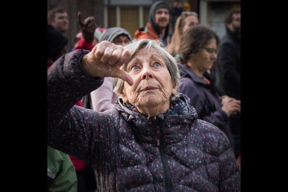 A woman gives the thumbs down sign in front of the Trump Tower during Saturday’s Vancouver Women’s March. When demonstrators arrived at the business of U.S. President Donald’s Trump, they turned their backs to it. Photo Rebecca Blissett. Read story here.