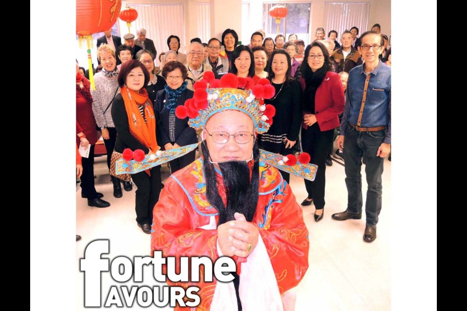 Members and the committee of the Richmond Chinese Community Society gather with the God of Fortune to celebrate Chinese New Year. The non-profit society has been helping Chinese immigrants integrate into their new lives in Richmond and Canada for the last 28 years.
