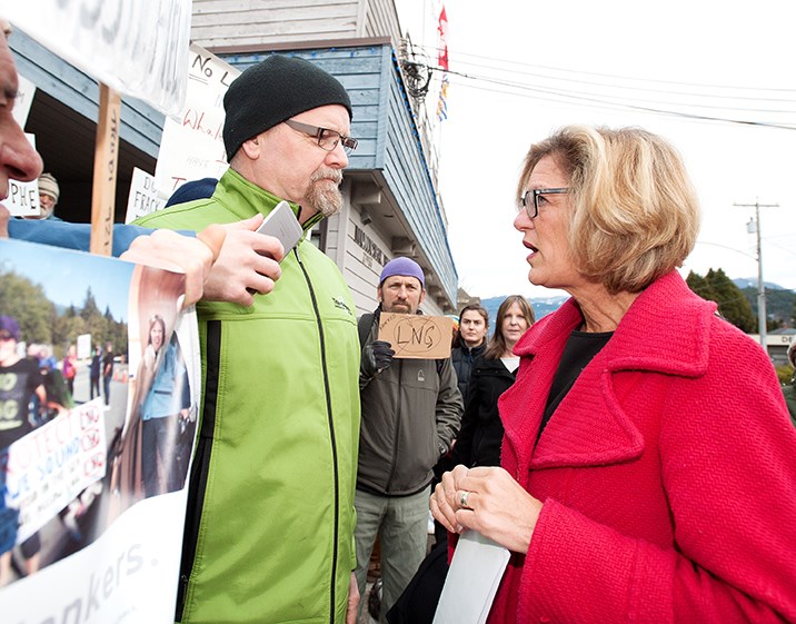 Demonstrator Peter Cooper confronts MP Pamela Goldsmith-Jones about the Woodfibre LNG project outside Squamish municipal hall.