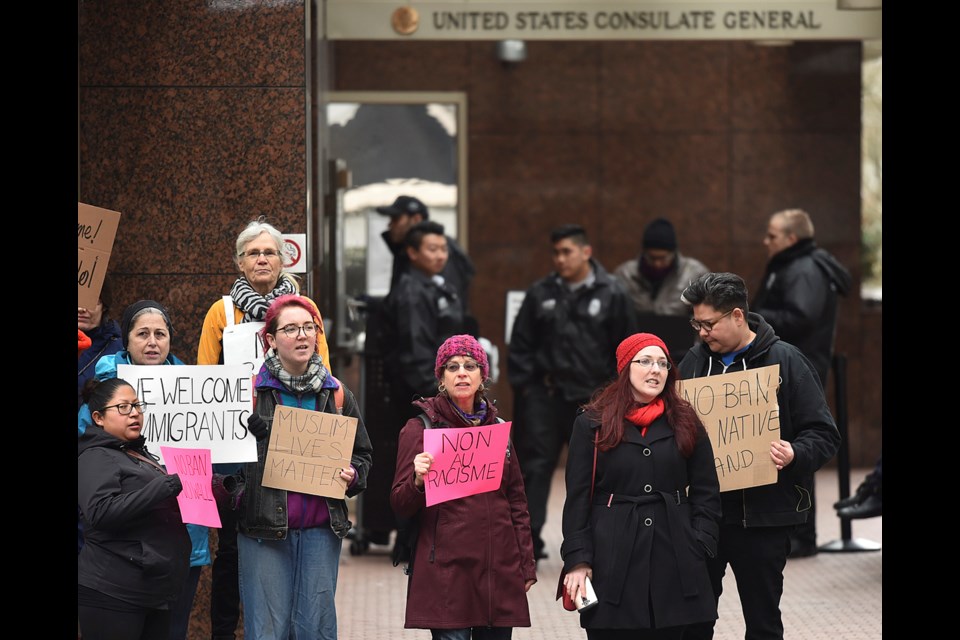 A small group of people protested U.S. president Donald Trump outside the U.S. Consulate General on West Pender in Vancouver. Photo Dan Toulgoet