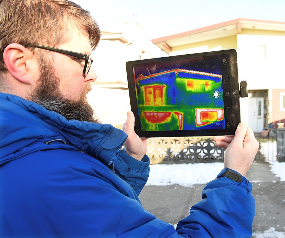 Chris Higgins, a green building planner for the City of Vancouver, demonstrates how a thermal imagin