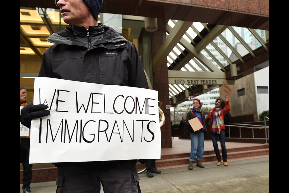 A small group of people protested U.S. president Donald Trump outside the U.S. Consulate General on West Pender in Vancouver. Photo Dan Toulgoet. Read story here.