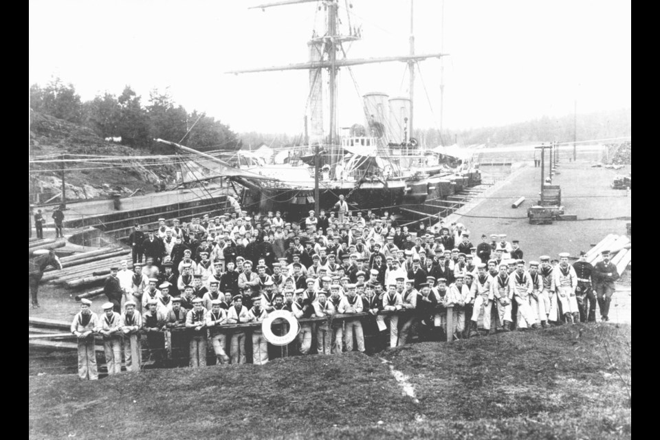 The ship's company of the protected cruiser second class HMS Leander at dock in Esquimalt, circa 1890s. Note the barbettes, or casements, housing the machine-movable guns.