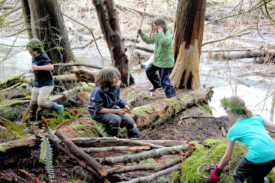 Wild Art participants play and explore in their forest village.