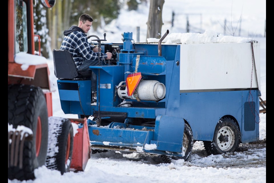 Marko Kardum leans on the Zamboni he and a friend tried out as a snowplow Monday night on a steep cul-de-sac on Tanner Ridge Place in Central Saanich.