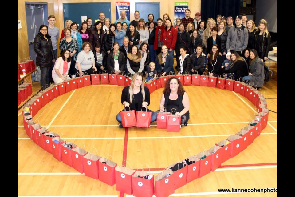 Courtney Cohen (front, left) and Lynne Fader (front, right) with some of the 1,000 care packages collected as part of the Rose’s Angels event, which was named after Cohen’s grandmother (left) Rose Lewin, seen with Courtney in 2012.