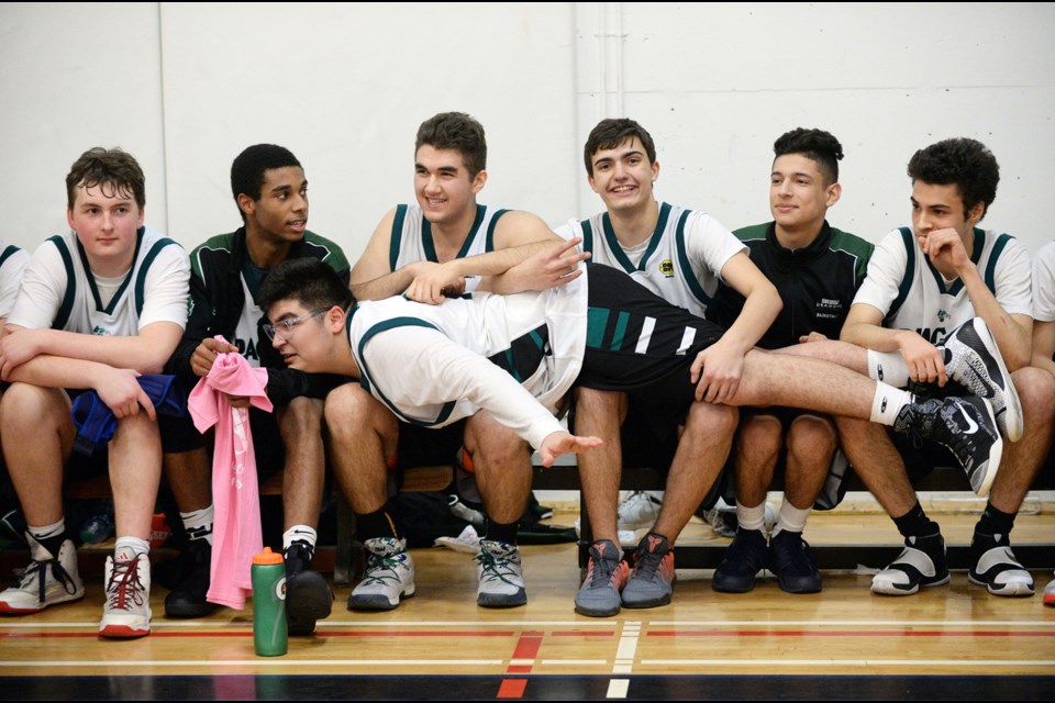 King George Dragon Nikan Najafi makes the most of the bench during in the senior boys AA/AAA city championship at Windermere secondary Feb. 10, 2017. Photo Jennifer Gauthier. Read story here.