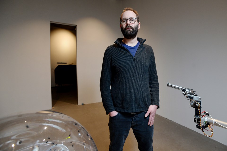 Artist David Bowen with fly revolver, part of the new exhibition BRINK opening Feb. 24 at the New Media Gallery.