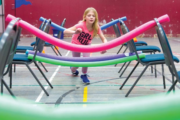 Emily Neufeld flies through the obstacle course during the fourth annual Family Fun Craft Day at Ladner Baptist Church Saturday afternoon.