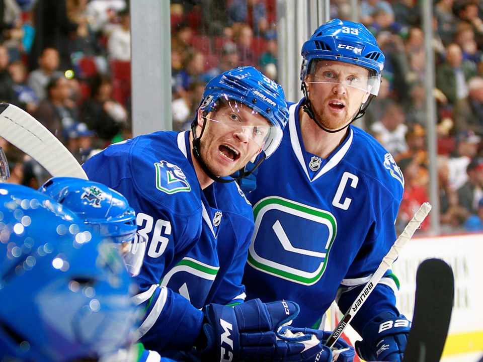 Jannik Hansen might be upset and Henrik Sedin is interested in what is going on