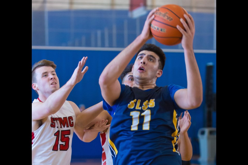 Steveston-London's Fardaws Aimaq goes up for two of his 43 points in an 80-76 win over the St. Thomas More Knights in semi-final action Wednesday at the Lower Mainland "AAA" Championships at the Richmond Olympic Oval. The Sharks will play Byrne Creek in the title game Friday at 6:15 p.m.