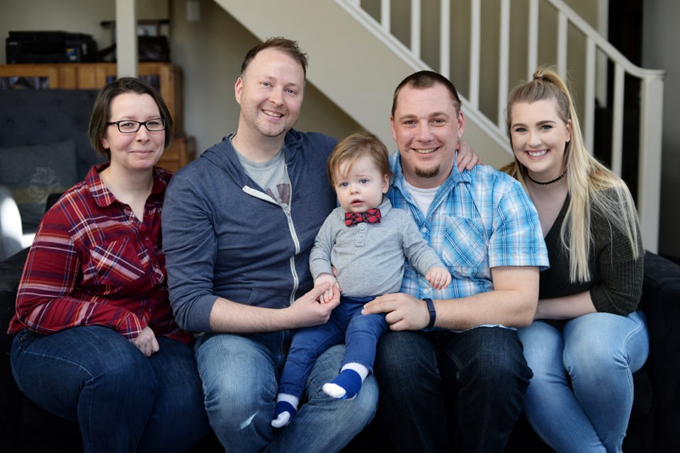 A precious gift: From left, Jessie Jodoin, Chris Jodoin, Spencer David Jodoin, Mike Tiney and his sister, Chelsea Tiney. Spencer, Mike and Chris’ son, was created from Chris’ sperm and Chelsea’s egg (Jessie was the surrogate). The gay couple wanted to have a child as genetically close to them as possible, and their siblings were all for the idea.