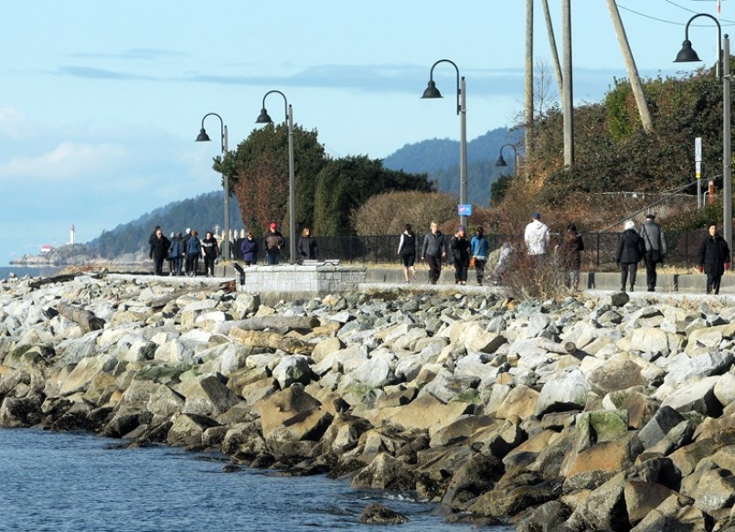 Young and old stroll West Vancouver’s Centennial Seawalk near 22nd Street on Thursday. The area is the subject of a dispute between CN and the district. Photo Mike Wakefield North Shore News