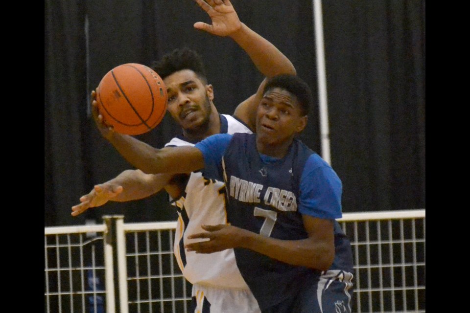 Steveston-London's Isaiah Hunter and Byrne Creek's Martin Djunga battle for a rebound during Friday's Lower Mainland "AAA" final at the Richmond Olympic Oval. The Bulldogs pulled away in the last going for a 101-92 victory.