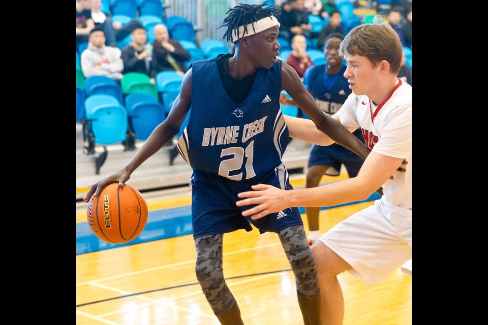 The Byrne Creek Bulldogs' Wel Deng holds off a Lord Byng defender while scouting out his options. Byrne Creek now heads to next week’s B.C. senior boys 3-A championship tournament in Langley, after capturing the Lower Mainland crown last week.