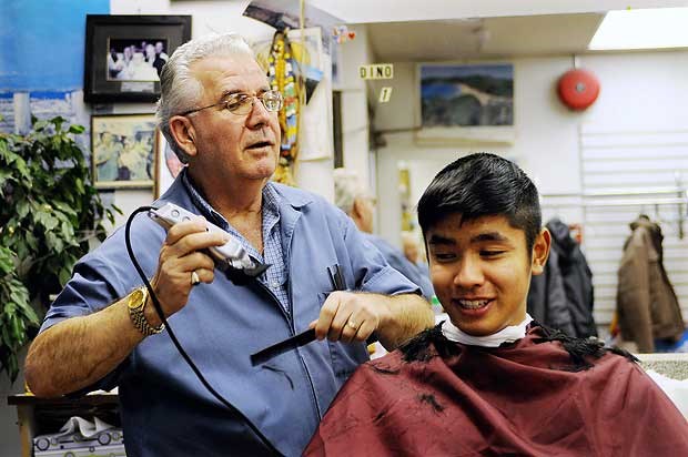 Kerrisdale Life: Longtime Kerrisdale barber Dino Avanitis gives Justin Ho, a haircut at his West Boulevard barber shop. Avanitis opened Economy Barber Shop 33 years ago.